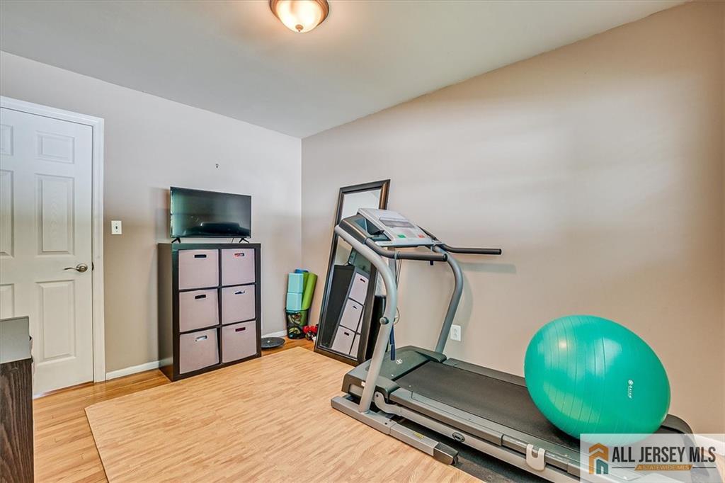 20 Melville Road Edison, NJ 08817 - Photo 17 of 31 a room with gym equipment and wooden floor