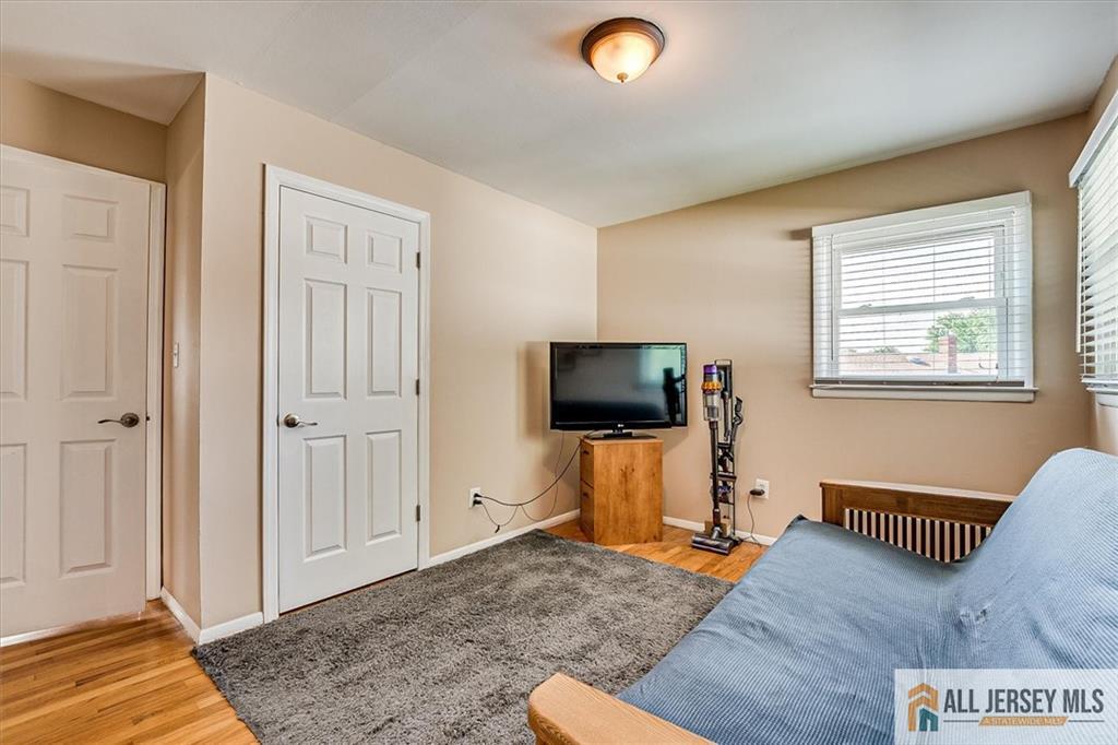 20 Melville Road Edison, NJ 08817 - Photo 19 of 31 a living room with furniture and a flat screen tv