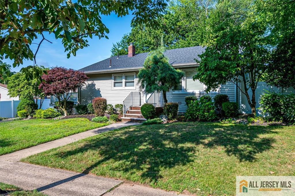 20 Melville Road Edison, NJ 08817 - Photo 3 of 31 a front view of a house with a yard