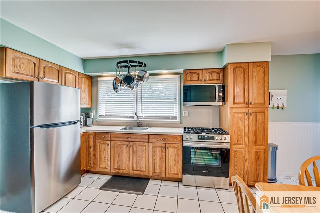 20 Melville Road Edison, NJ 08817 - Photo 9 of 31 a kitchen with stainless steel appliances a refrigerator and a stove top oven