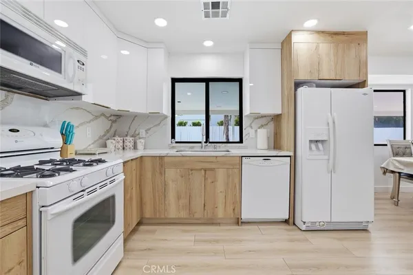 a kitchen with a stove a refrigerator and a sink
