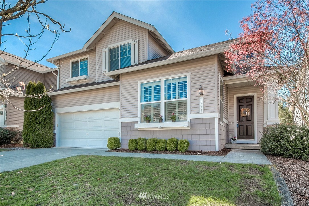 28003 Maple Ridge Way Southeast Maple Valley, WA 98038 - Photo 1 of 22 a front view of a house with a yard