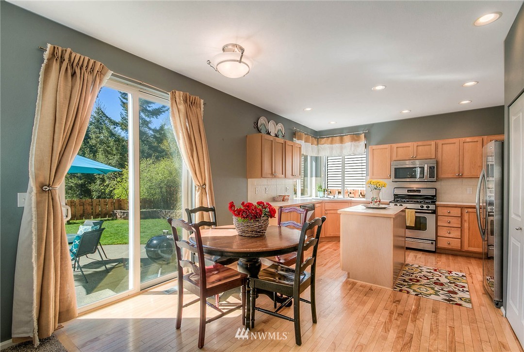 28003 Maple Ridge Way Southeast Maple Valley, WA 98038 - Photo 10 of 22 a dining room with furniture window and wooden floor