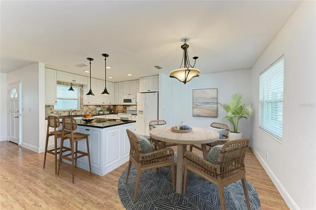 a kitchen with a dining table and chairs
