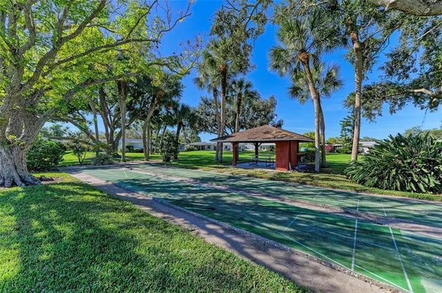 a view of a house with backyard and a sitting area
