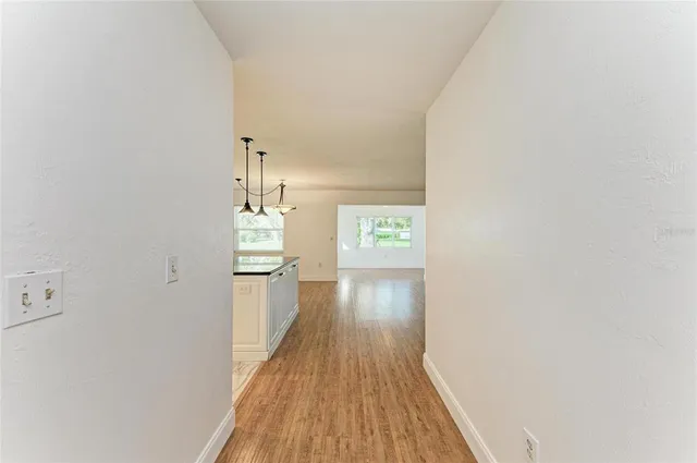 a view of a hallway with wooden floor