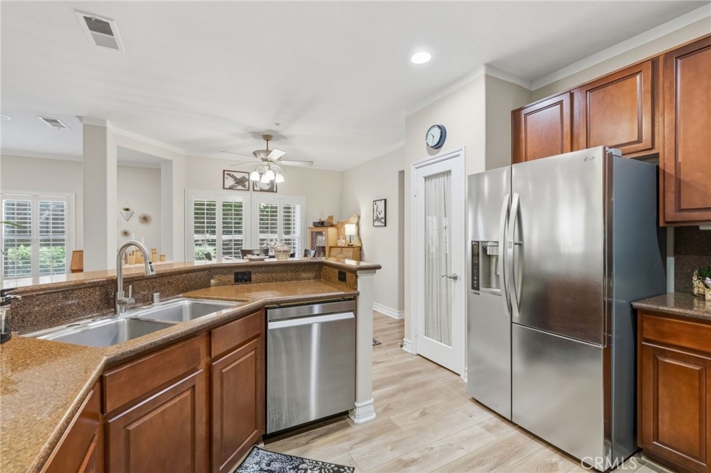 7331 Shelby Place, Unit 84 Rancho Cucamonga, CA 91739 - Photo 14 of 43 a kitchen with stainless steel appliances granite countertop a refrigerator and a sink