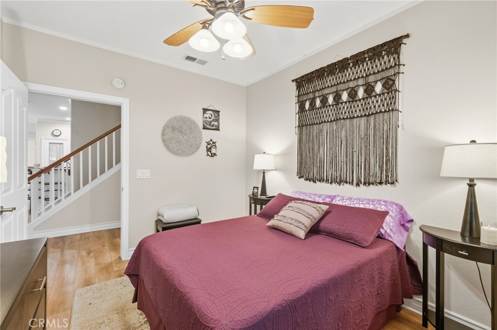 7331 Shelby Place, Unit 84 Rancho Cucamonga, CA 91739 - Photo 16 of 43 a bedroom with a bed and a chandelier