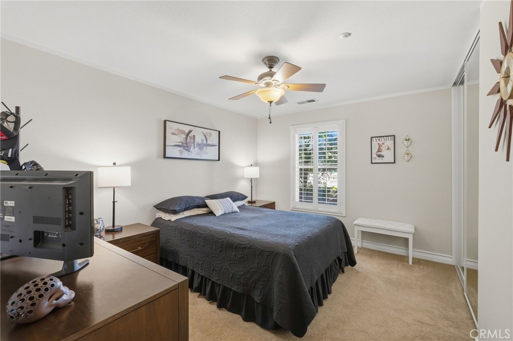 7331 Shelby Place, Unit 84 Rancho Cucamonga, CA 91739 - Photo 27 of 43 a bedroom with a bed and a chandelier
