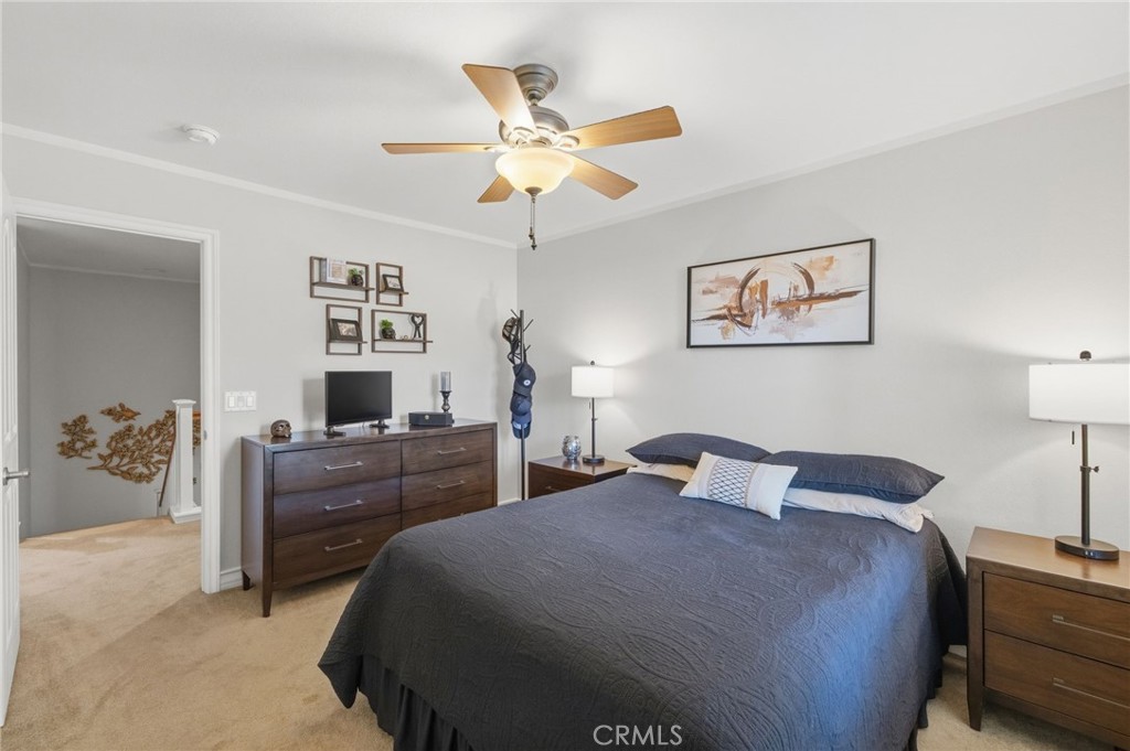 7331 Shelby Place, Unit 84 Rancho Cucamonga, CA 91739 - Photo 28 of 43 a bedroom with a bed and a chandelier