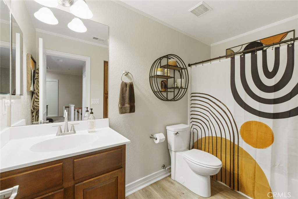 7331 Shelby Place, Unit 84 Rancho Cucamonga, CA 91739 - Photo 29 of 43 a bathroom with a sink a mirror a toilet and a mirror