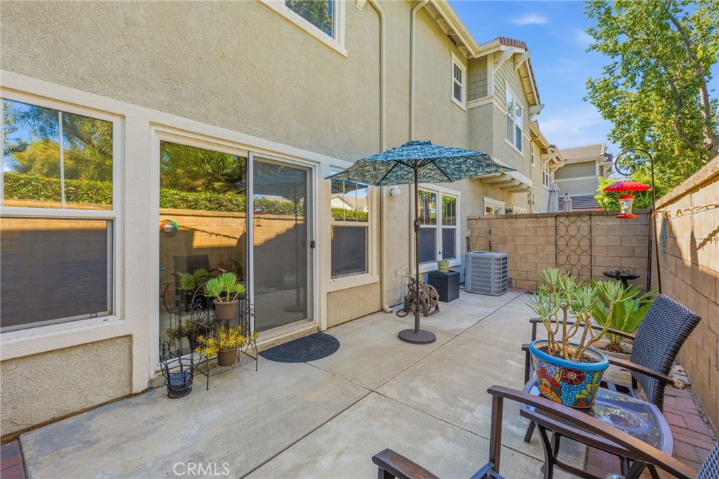7331 Shelby Place, Unit 84 Rancho Cucamonga, CA 91739 - Photo 36 of 43 a view of a patio with a table and chairs under an umbrella