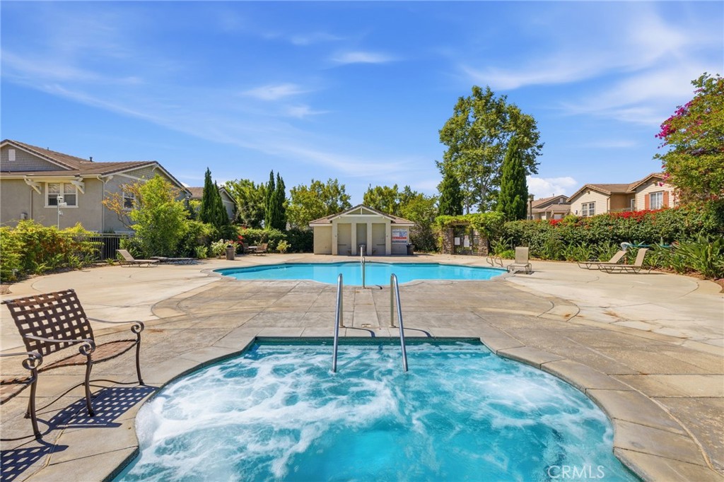 7331 Shelby Place, Unit 84 Rancho Cucamonga, CA 91739 - Photo 40 of 43 a view of a garden with a bench in front of the house