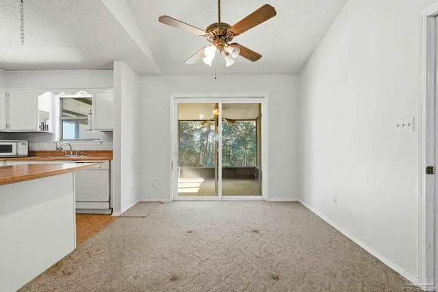 a large kitchen with cabinets a sink and a stove