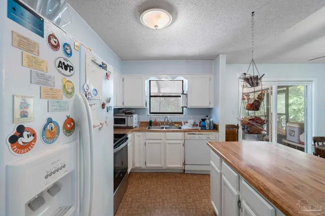 a kitchen with a sink a stove and refrigerator