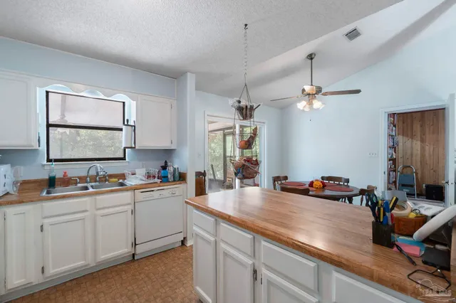 a kitchen with a sink appliances and cabinets