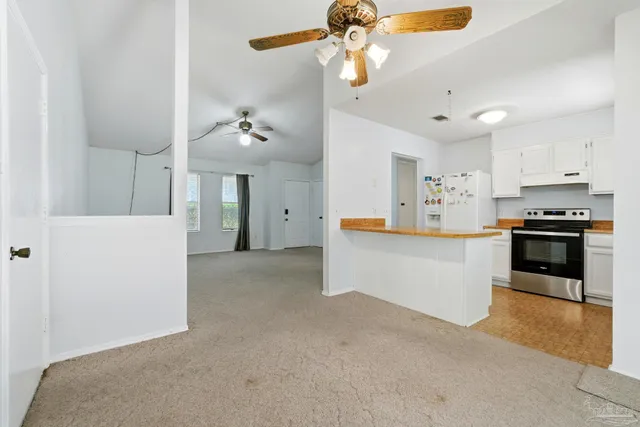 a kitchen with stainless steel appliances a stove a sink a refrigerator and cabinets