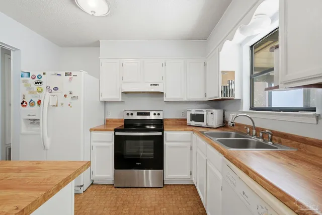a kitchen with a sink stove and cabinets