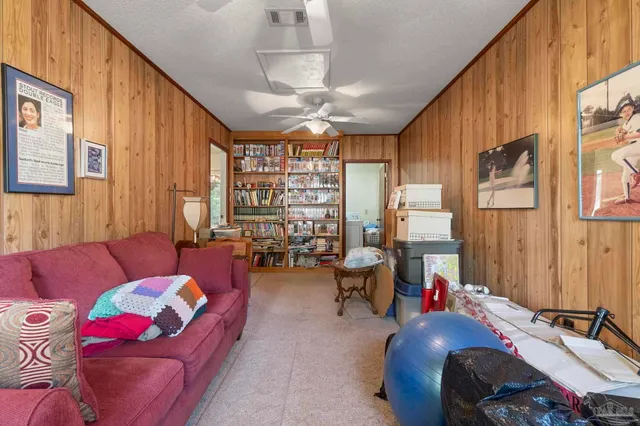 a bedroom with furniture and a large window
