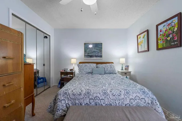 a bedroom with a bed and a painting on the wall