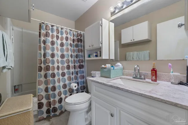 a bathroom with a double vanity sink toilet and shower