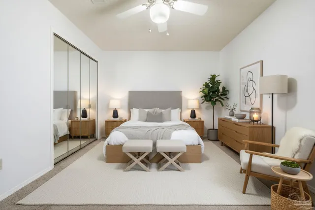 an empty room with a chandelier fan