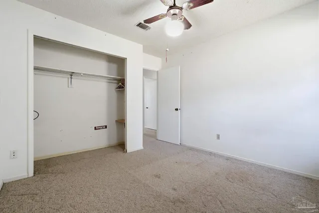 a view of a room with gym equipment and large windows