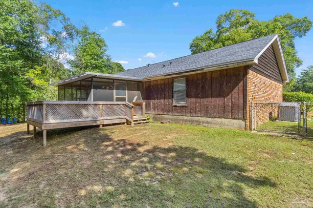 a backyard of a house with yard and trampoline