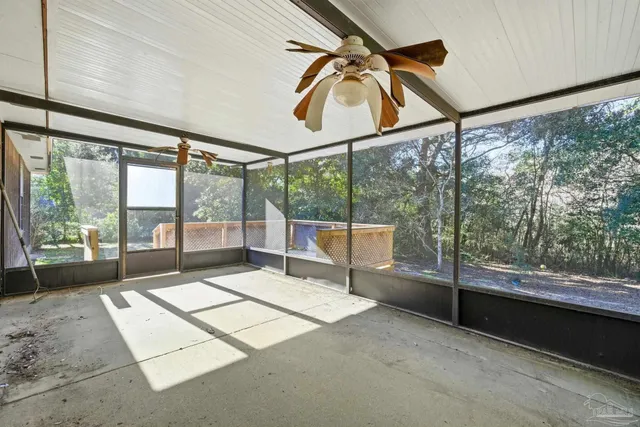 a room with pool table and windows