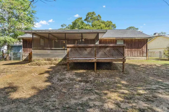 an aerial view of a house with a yard and outdoor seating