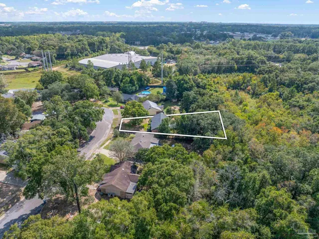 an aerial view of residential houses with outdoor space and city view