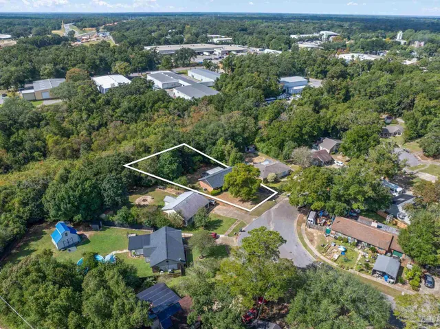 an aerial view of a house with yard