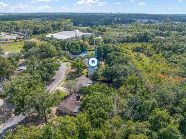 an aerial view of residential houses with outdoor space and city view