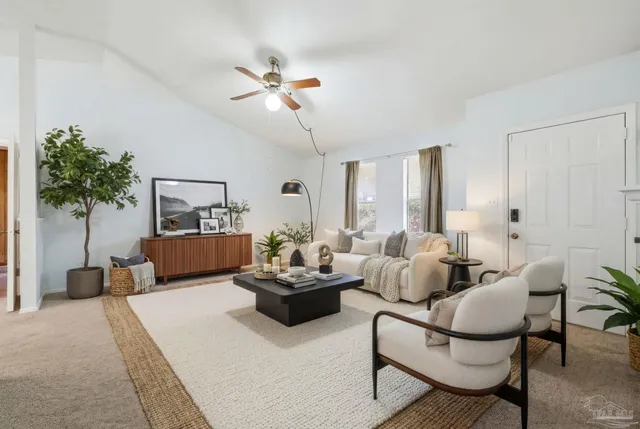 a living room with furniture and a potted plant