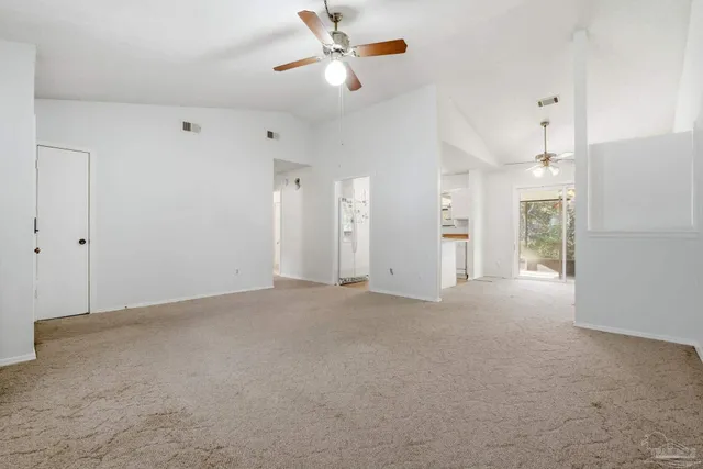 a dining room with furniture a chandelier and a rug
