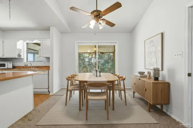 a view of a kitchen with a sink and a chandelier fan
