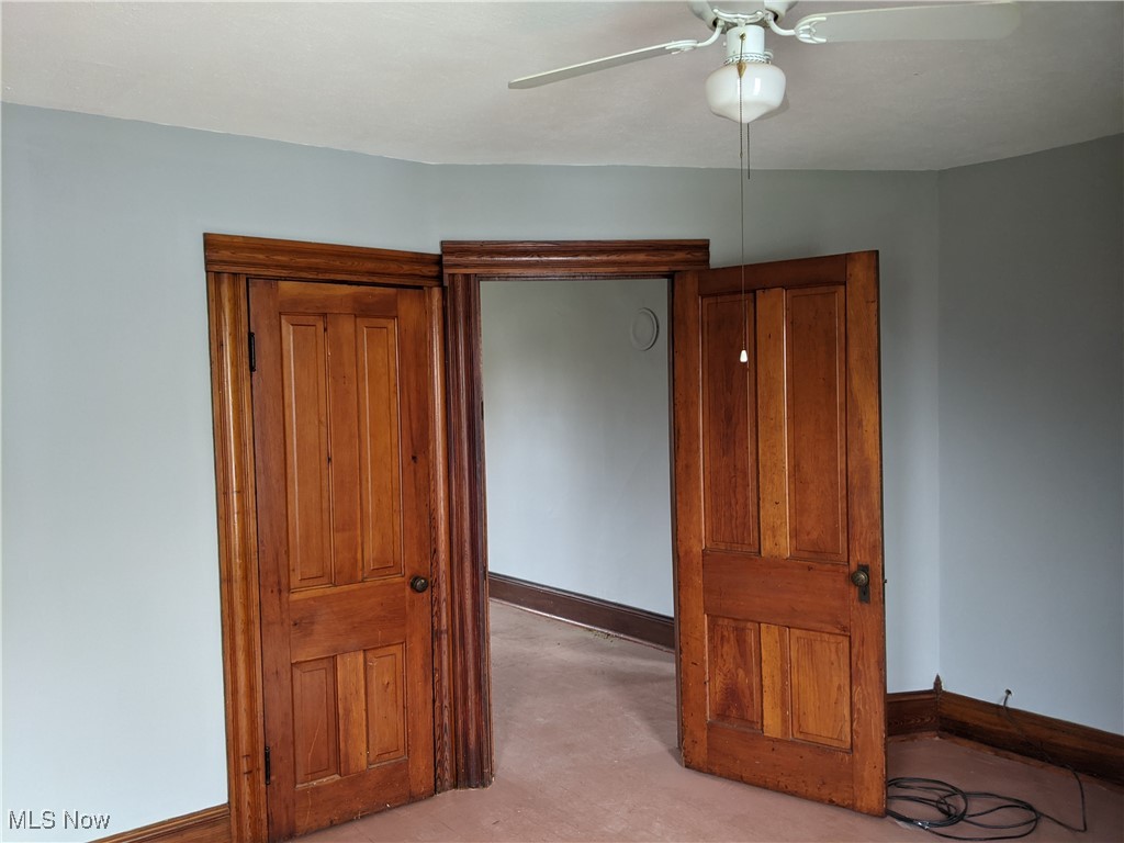 70 Center Road Bedford, OH 44146 - Photo 15 of 18 Unfurnished room featuring light carpet and ceiling fan