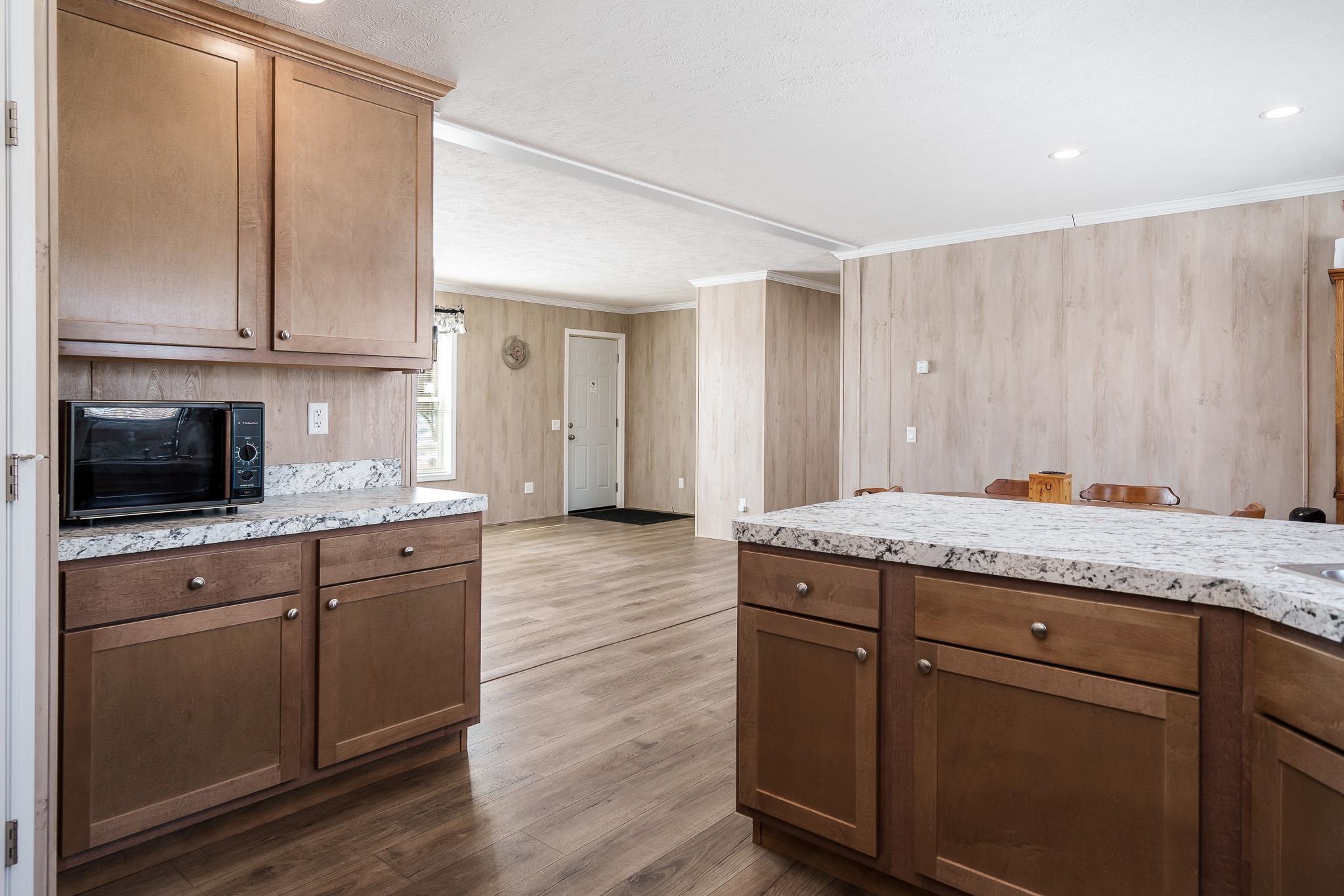 11447 South County Rd K Beloit, WI 53511 - Photo 23 of 51 a living room with granite countertop kitchen island wooden floor and stainless steel appliances