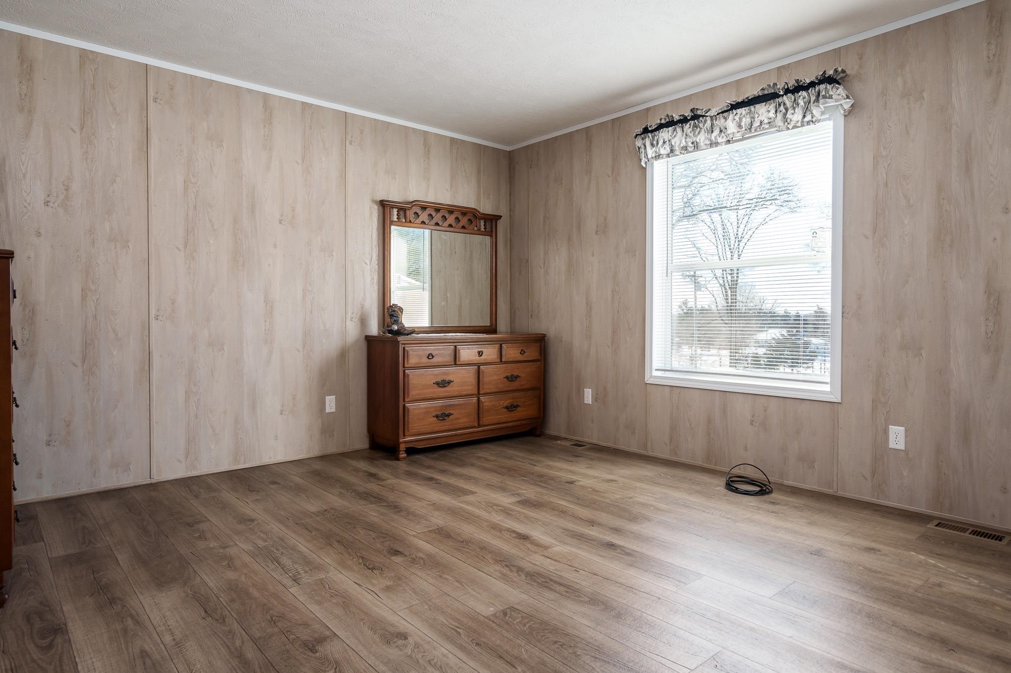 11447 South County Rd K Beloit, WI 53511 - Photo 27 of 51 a view of an empty room with a window and wooden floor
