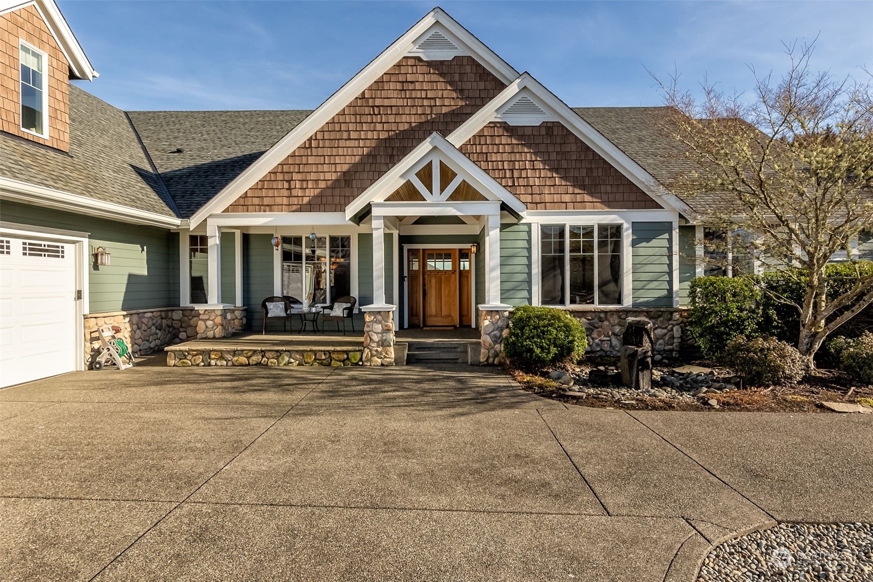 9306 Milburn Loop Southeast Olympia, WA 98513 - Photo 2 of 40 a view of a house with sitting area and garden