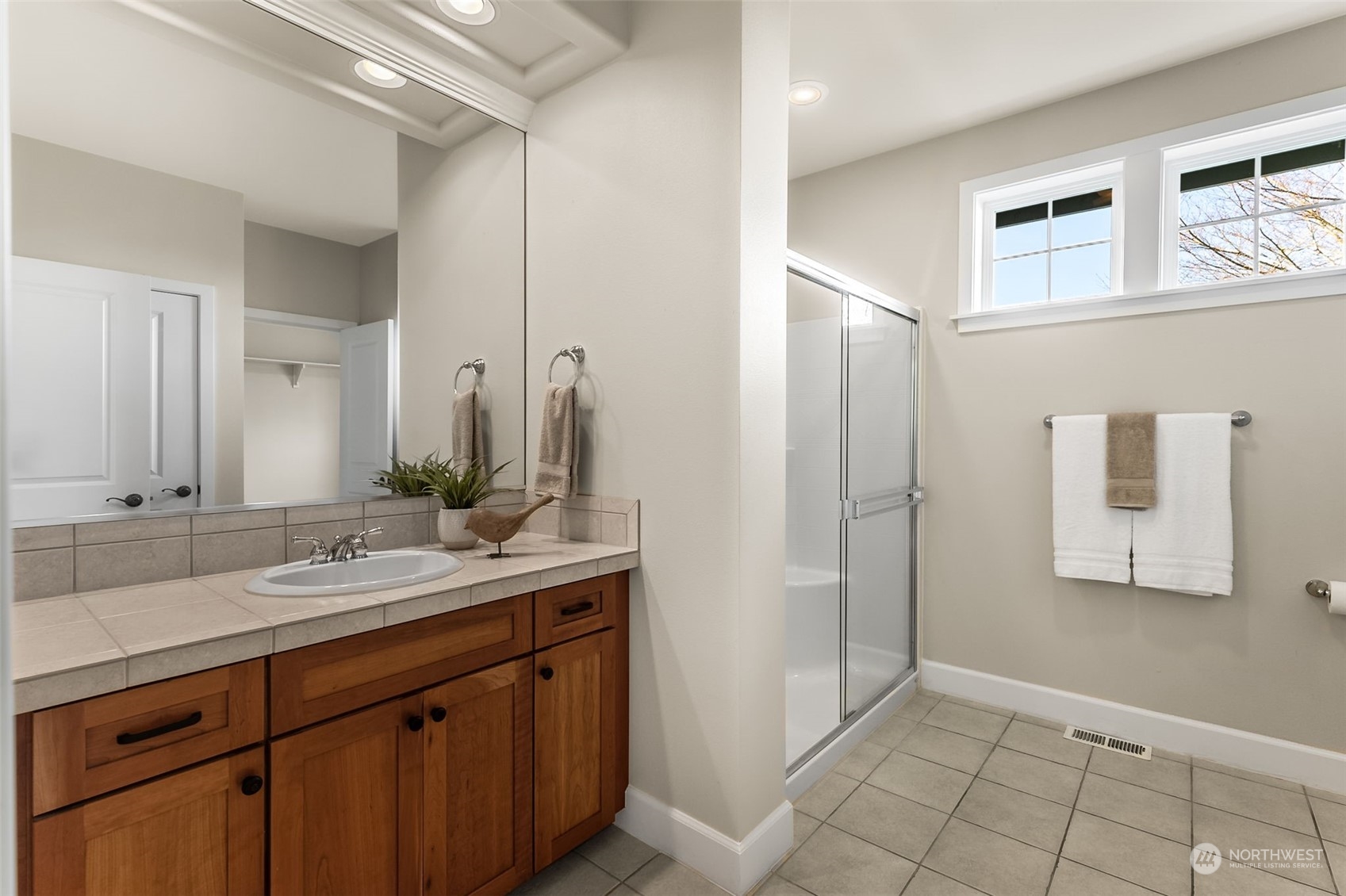 9306 Milburn Loop Southeast Olympia, WA 98513 - Photo 23 of 40 a bathroom with a sink and a mirror
