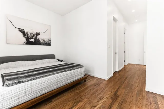 a view of a bedroom with wooden floor
