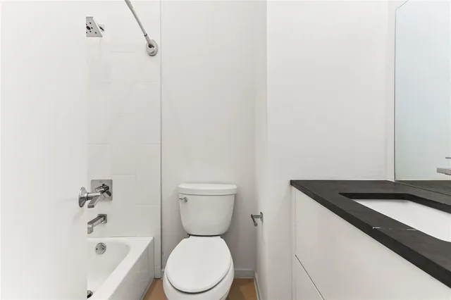 a bathroom with a toilet and a bathtub
