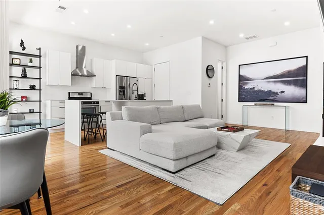 a living room with furniture and kitchen view