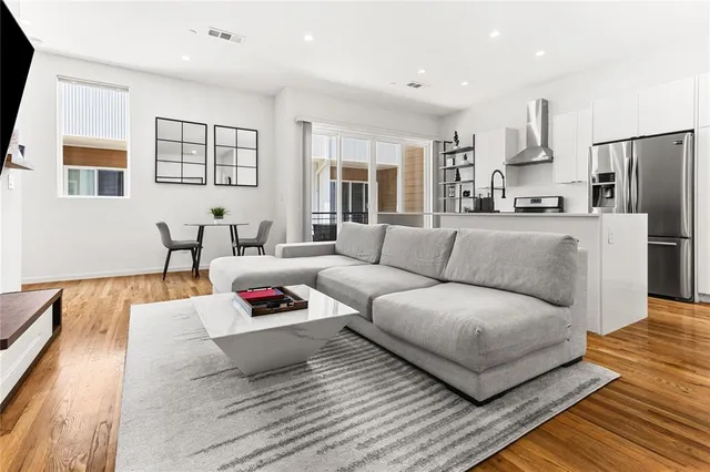 a living room with furniture and kitchen view