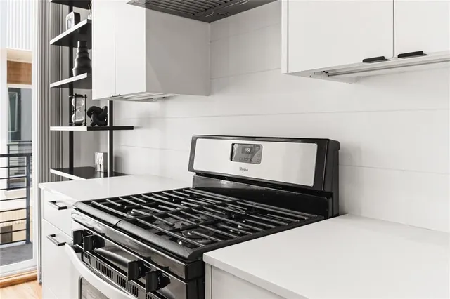 a stove top oven sitting inside of a kitchen