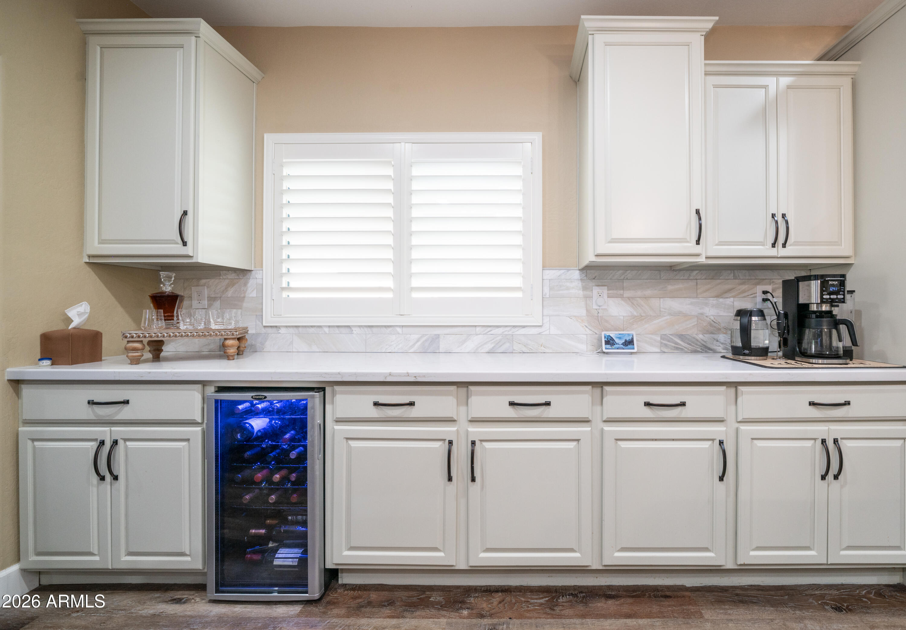 10754 West Yearling Road Peoria, AZ 85383 - Photo 11 of 35 a kitchen with granite countertop white cabinets and white appliances