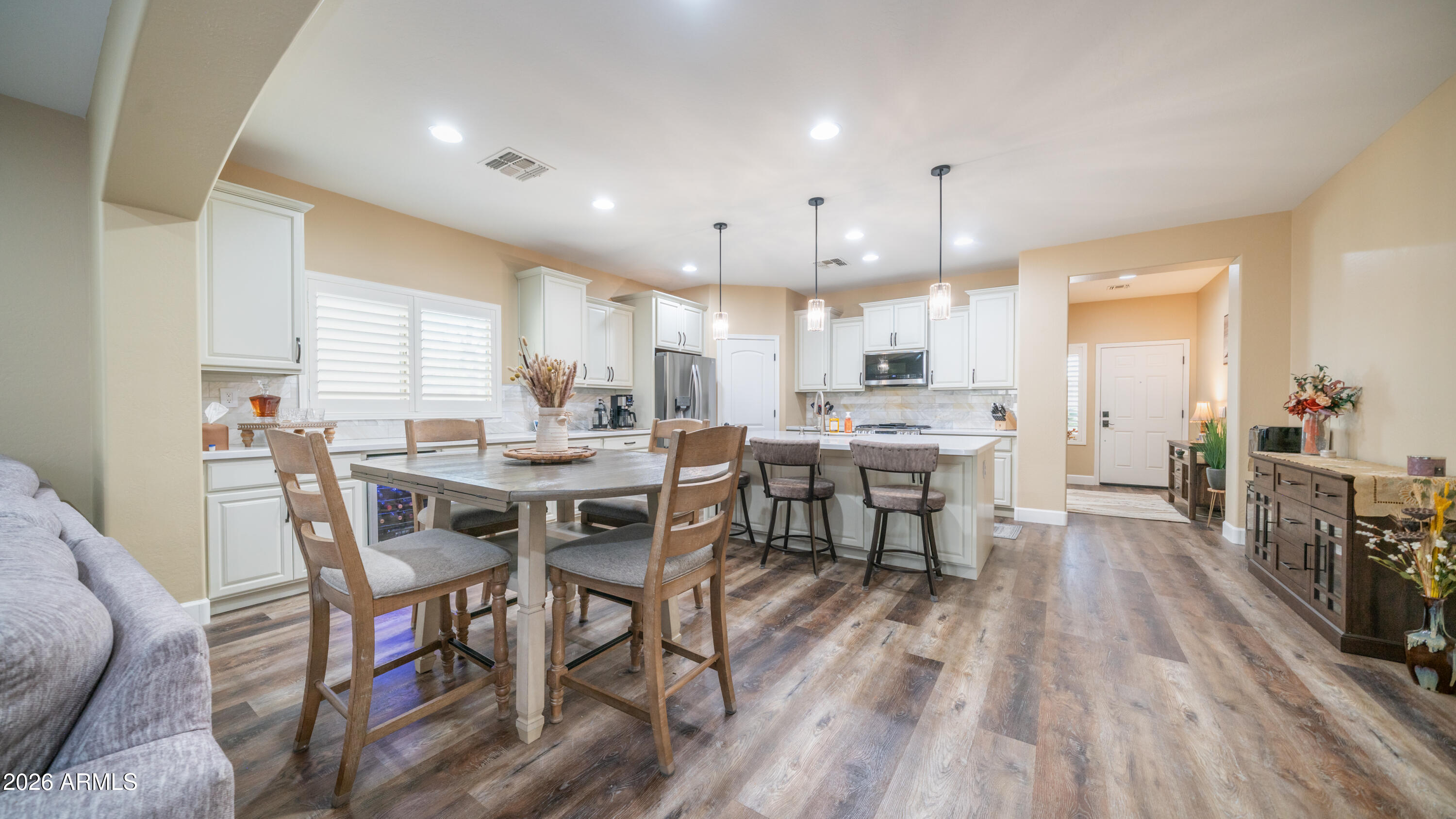 10754 West Yearling Road Peoria, AZ 85383 - Photo 12 of 35 a view of a dining room with furniture and wooden floor