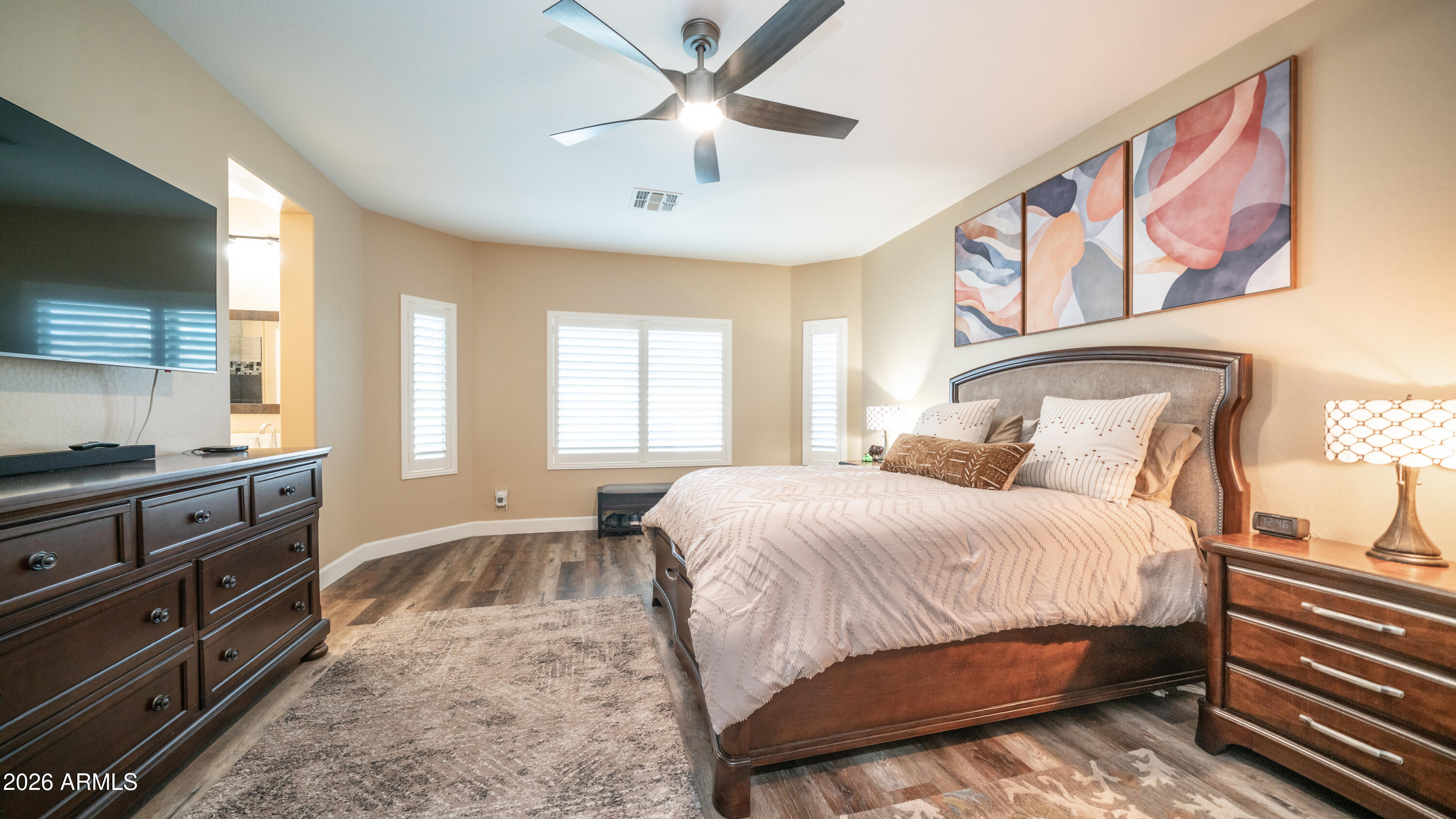 10754 West Yearling Road Peoria, AZ 85383 - Photo 16 of 35 a bedroom with a bed and a chandelier