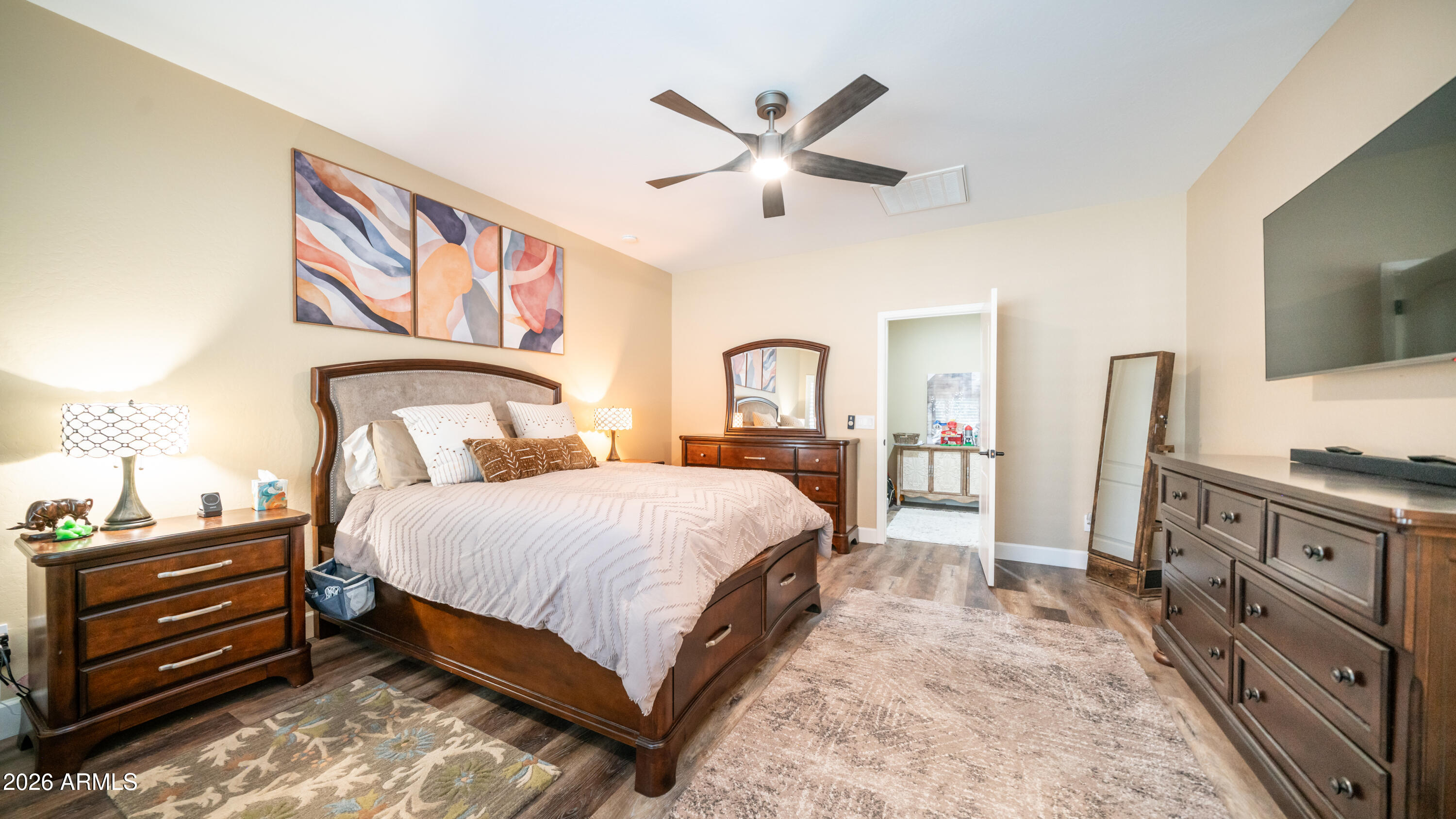 10754 West Yearling Road Peoria, AZ 85383 - Photo 17 of 35 a bedroom with a bed and a flat screen tv